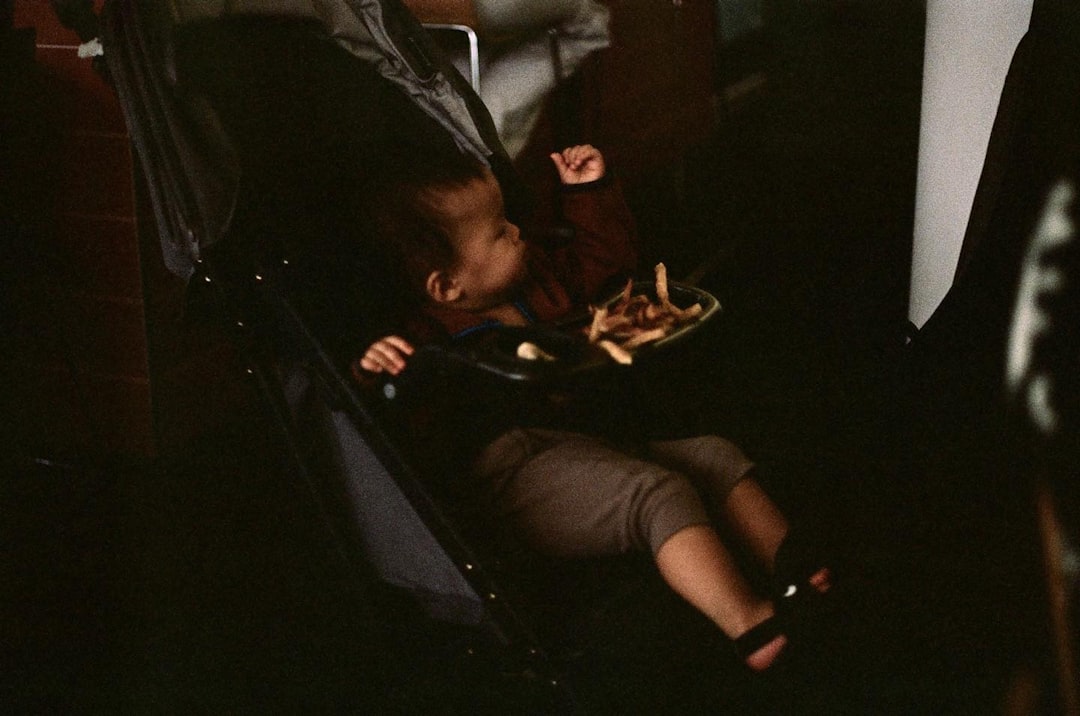 educator kneeling with child indoors