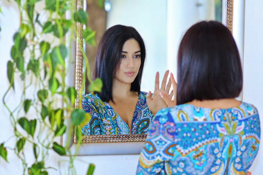 woman looking in mirror