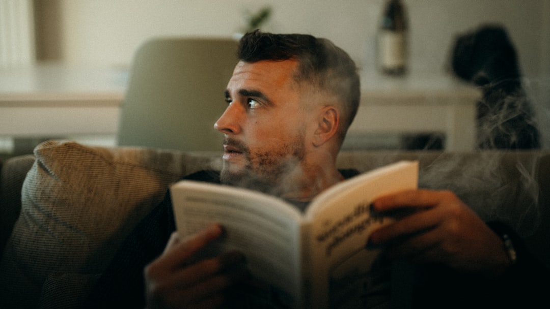 man relaxing with a book indoors